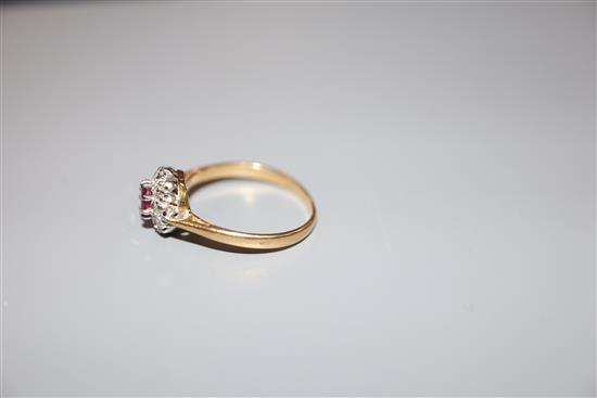 A mid 20th century yellow metal (stamped 18ct and Plat), ruby and diamond cluster ring, size L/M, gross 2.4 grams.